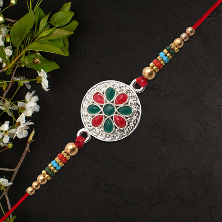 Silver Plated Floral Rakhi With Red Green Stones