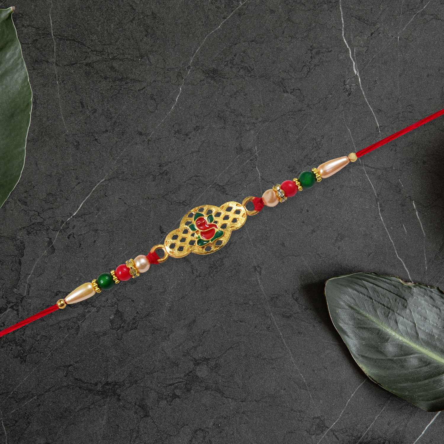 Religious Ganesha Rakhi In Gold Finish