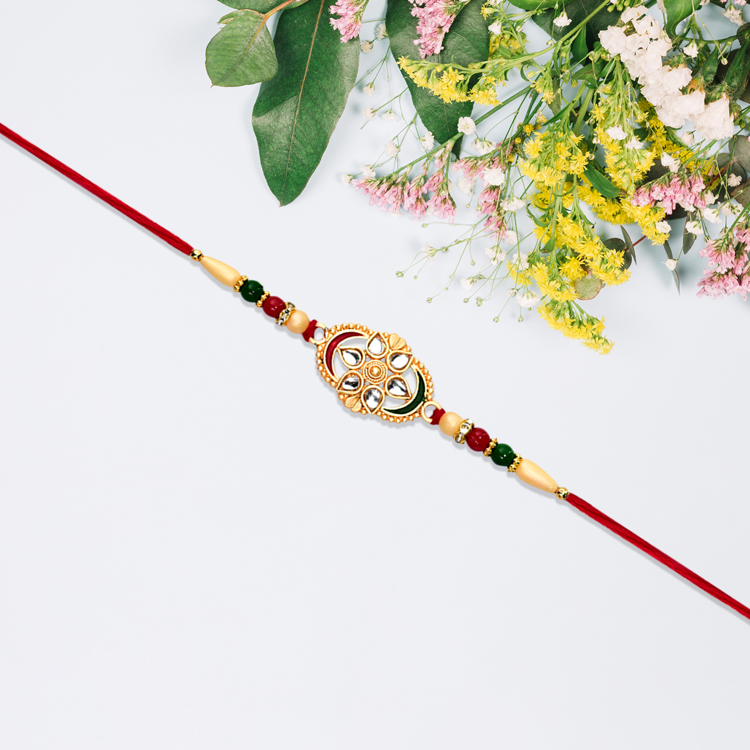 Traditional Oval Rakhi With Kundan Work And Red-green Beads